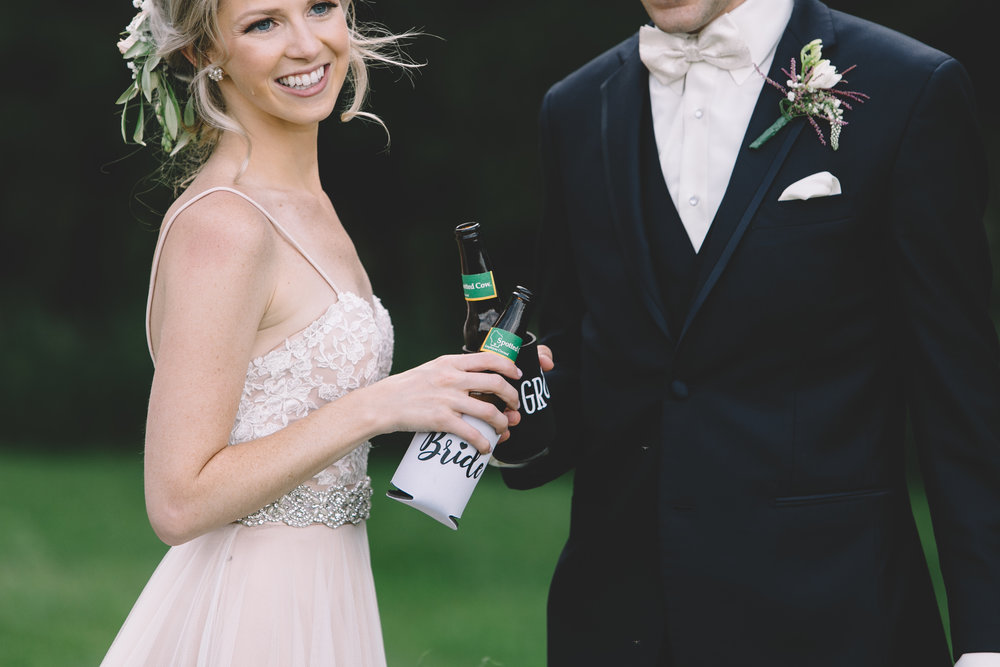 wedding photo with New Glarus Spotted Cow beer and bride and groom beer coozies