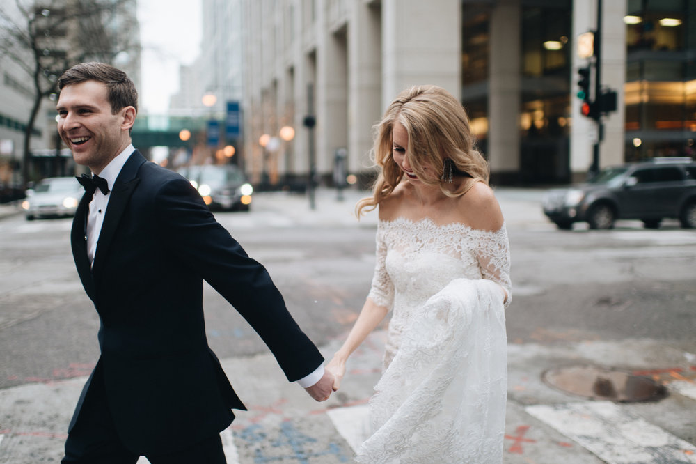 bride and groom walking the streets of Chicago in winter