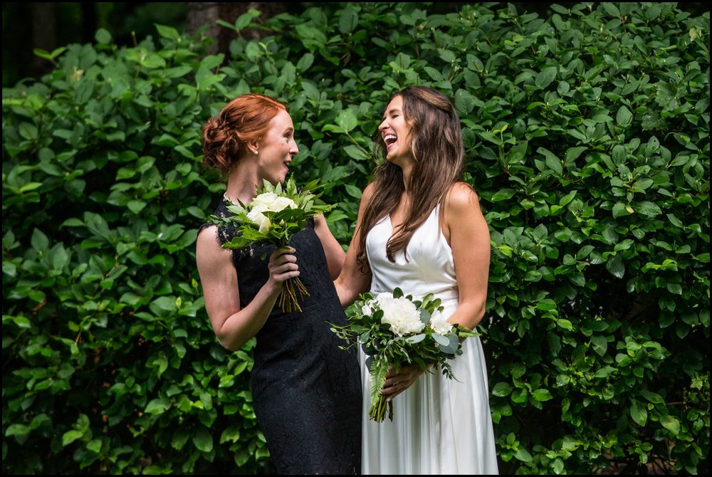  bride and her bridesmaid holding bouquets 