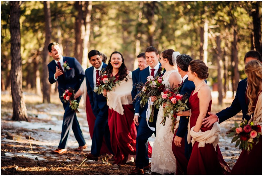  bridal party walking in the woods together 