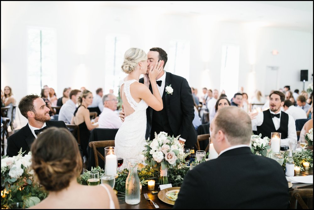  bride and groom kiss during reception 