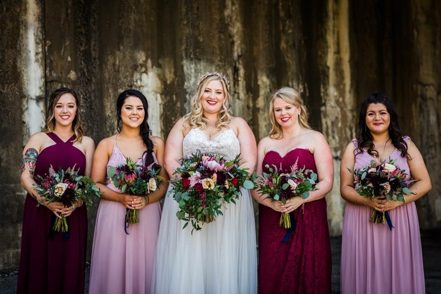  Bride and the bridesmaids holding wedding bouquets 