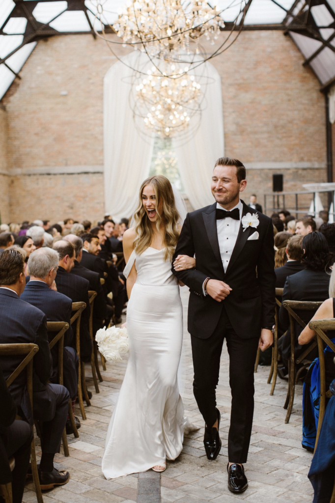 Couple leaving wedding ceremony at Bridgeport Art Center's Sculpture Garden