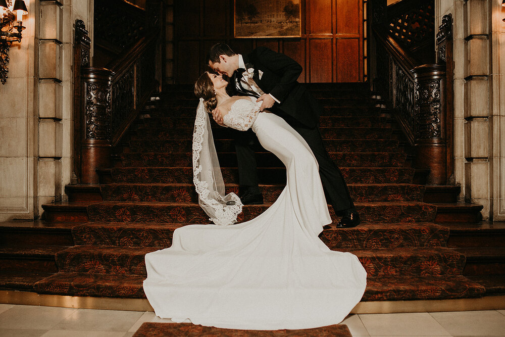 Wedding couple posing on staircase at University Club Chicago wedding