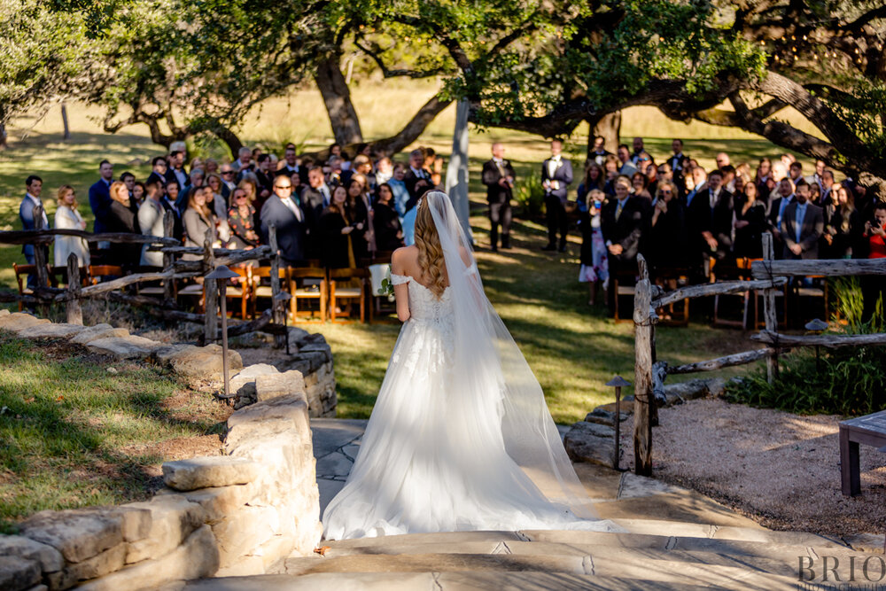 Bride walks down aisle at the Ivory Oak Wedding