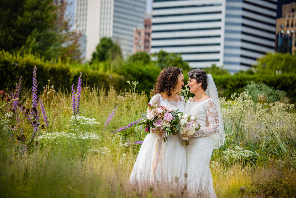 two brides in garden in downtown Chicago for LGBTQ wedding