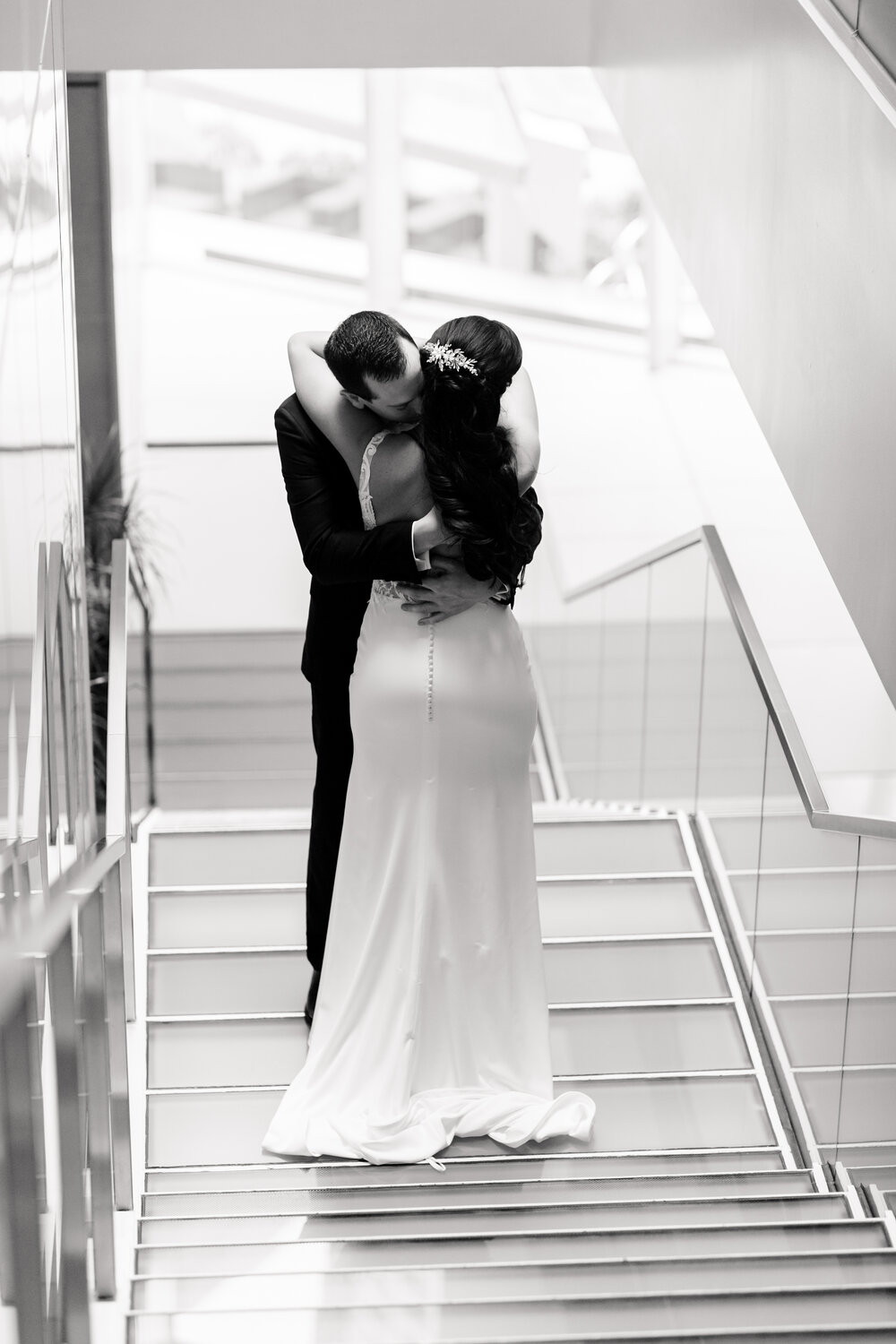 groom and brie embrace on staircase at sofitel chicago wedding