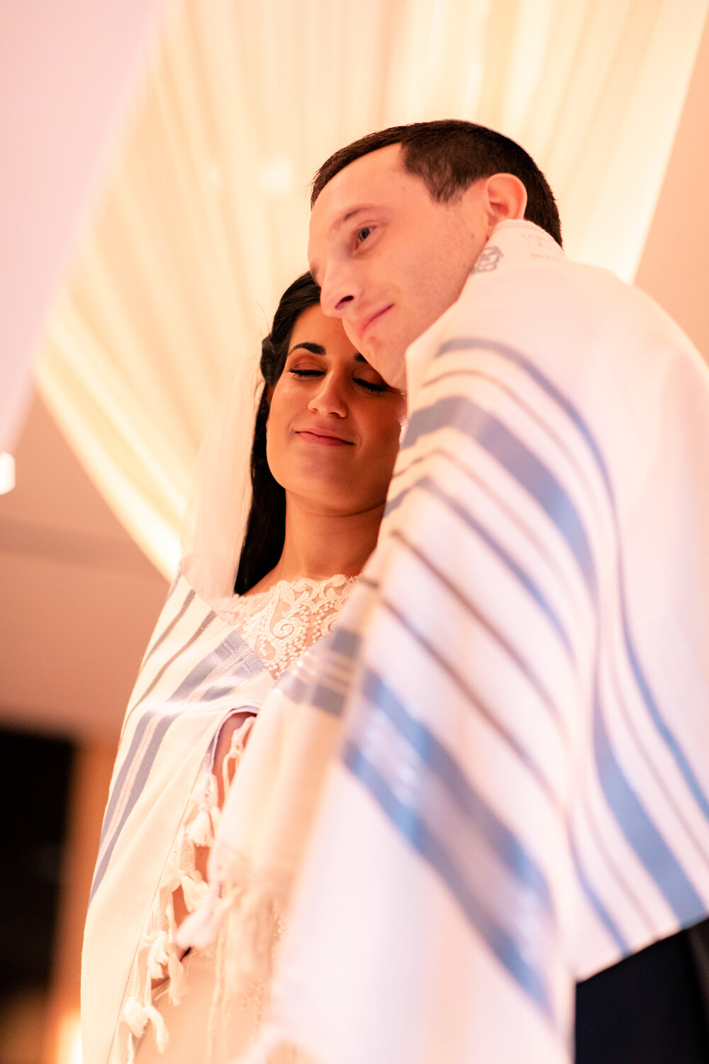 Bride and groom wrapped in Tallit at ceremony Sofitel Chicago wedding