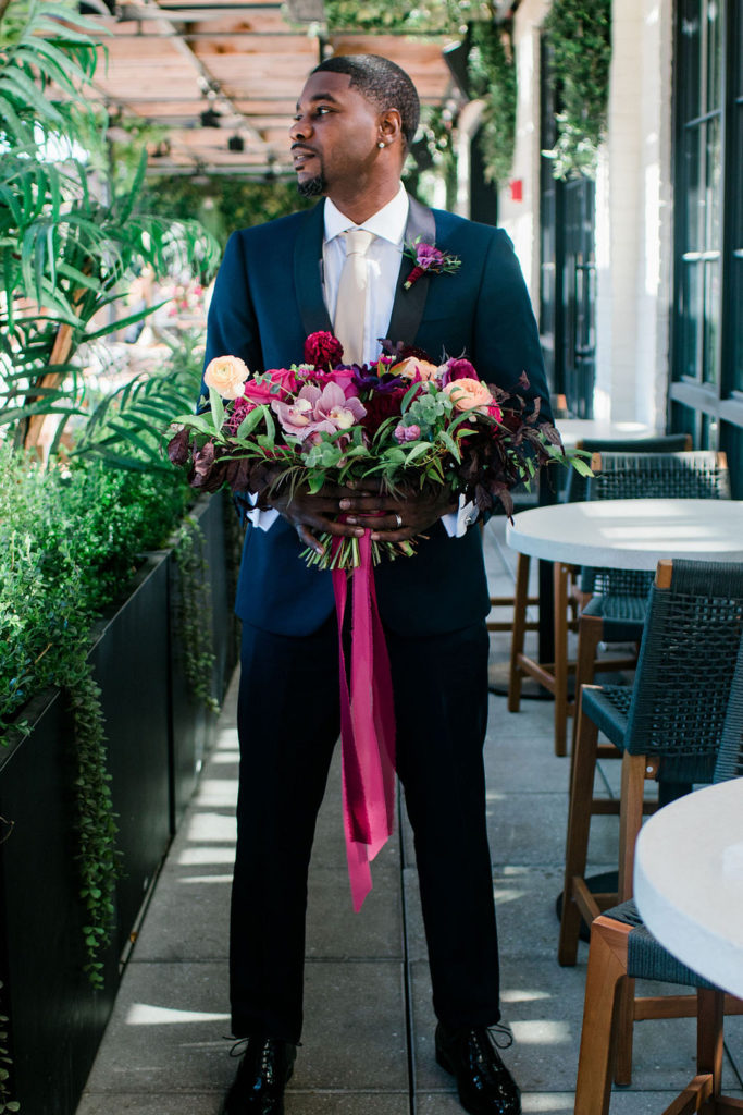 Groom holding bouquet at the dalcy wedding chicago photoshoot