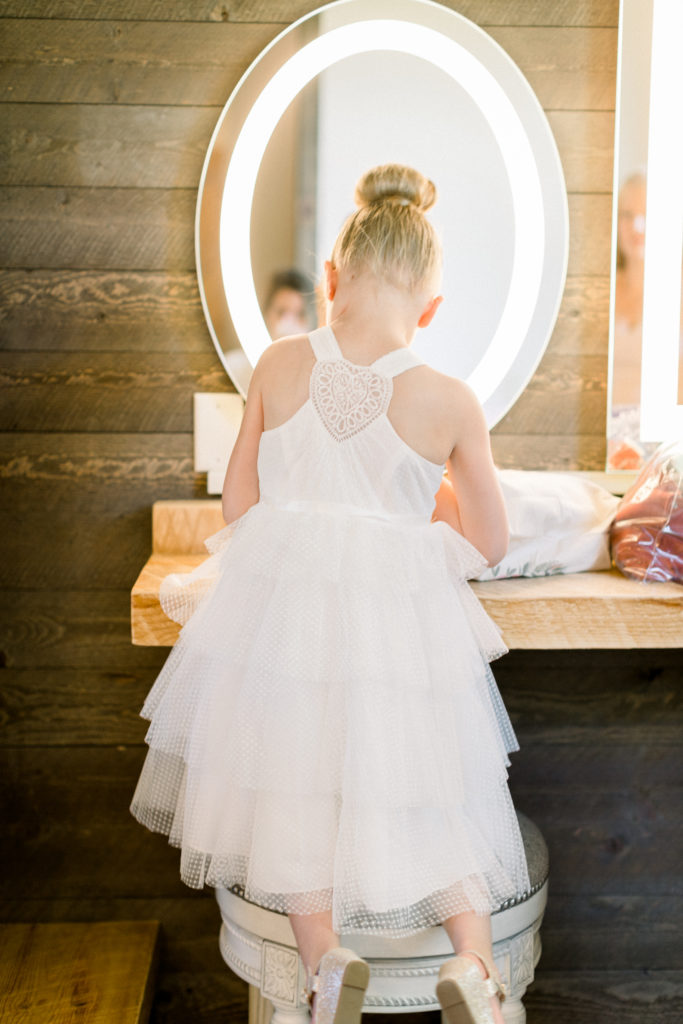 Flower girl getting ready for The Barn at Stoney Hills wedding