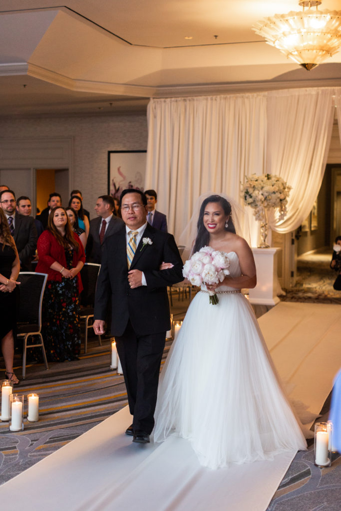 Walking down the aisle at Fairmont Hotel Chicago wedding