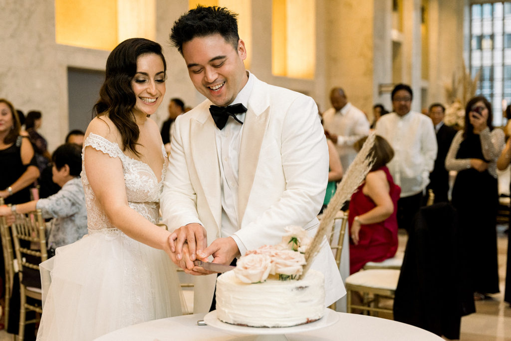 Bride and groom cutting cake at The Old Post Office Chicago wedding venue