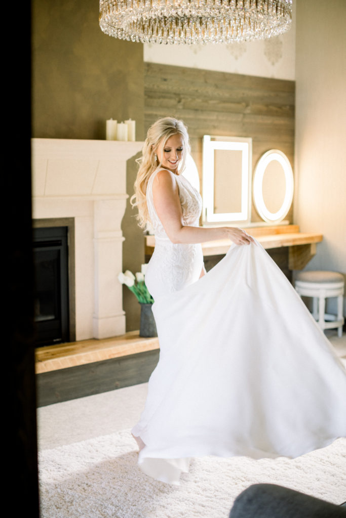 Bride dancing in her dress before her wedding at The Barn at Stoney Hills
