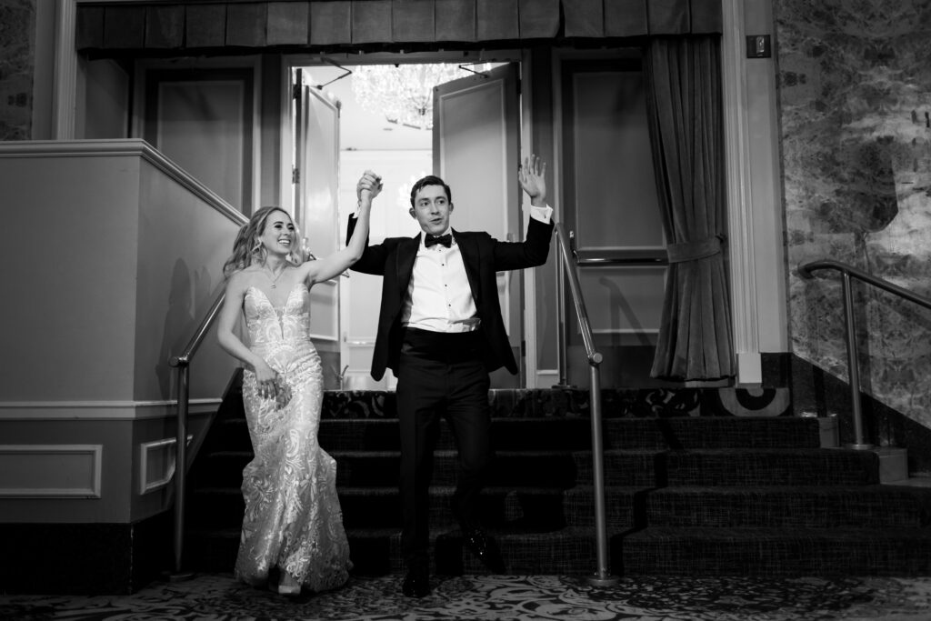 Bride and groom entering their wedding receptions at The Drake in Chicago