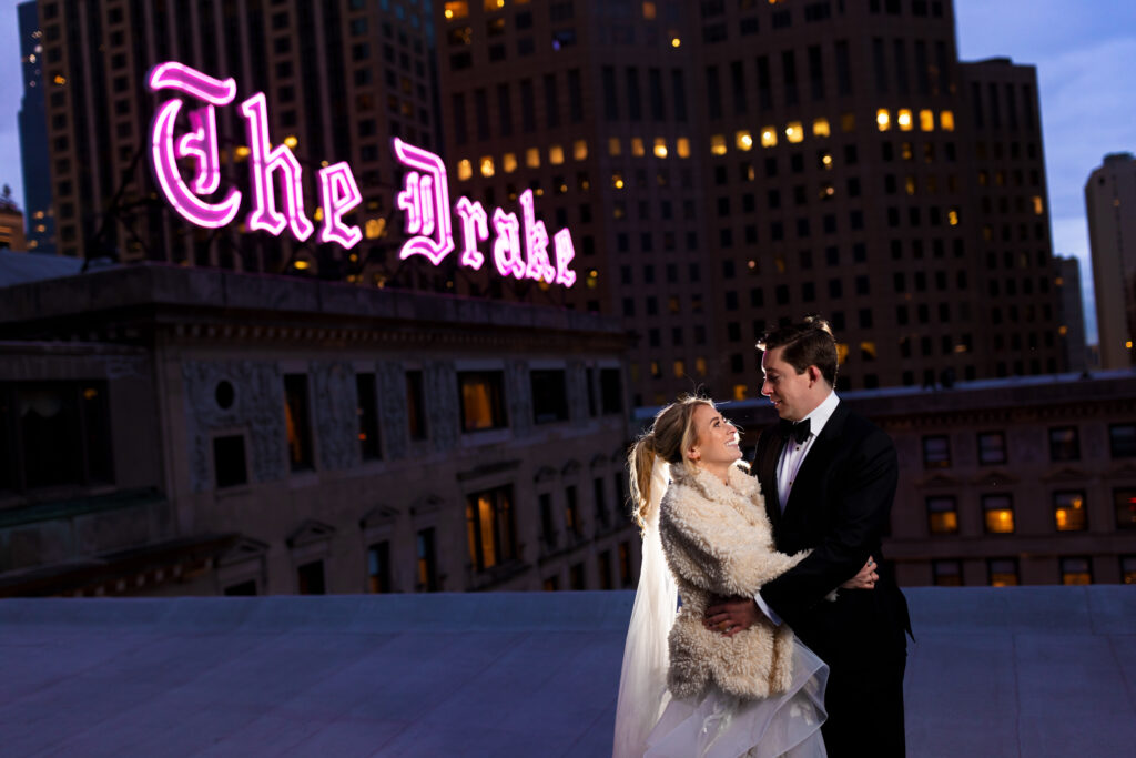 Bride and groom outside the Drake hotel with The Drake sign
