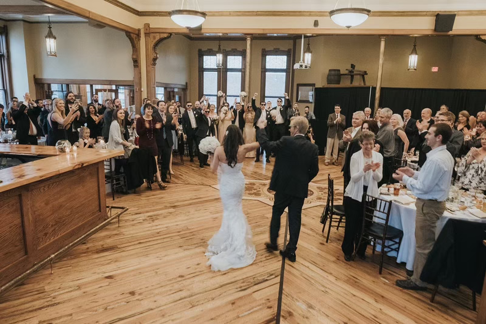 Bride and groom enter their reception at the historic Milwaukee wedding venue