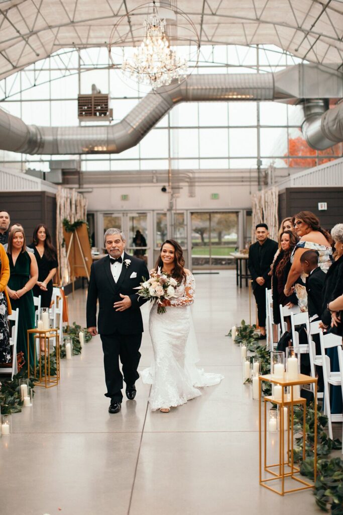Bride and Dad walking down the aisle of greenhouse venue