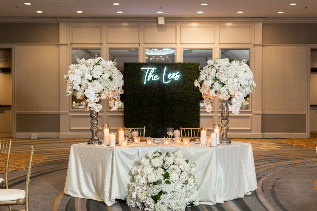 wedding sweetheart table with neon backdrop