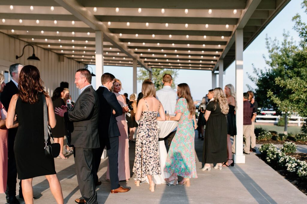 Cocktail reception on back patio with bistro lighting