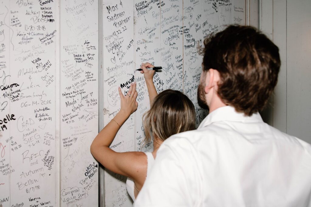 The Nest at Ruth Farms bride and groom signing memory wall.