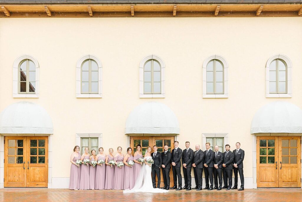 Wedding party posed in front of Sala Grande the Great Hall