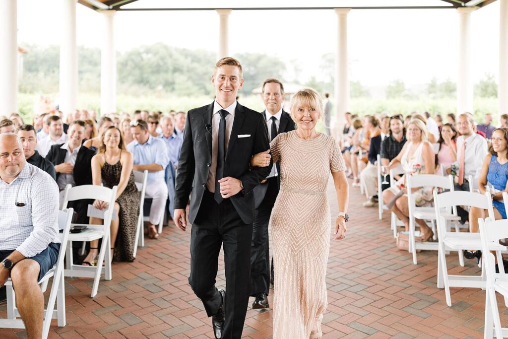 groom and mother walking down the aisle