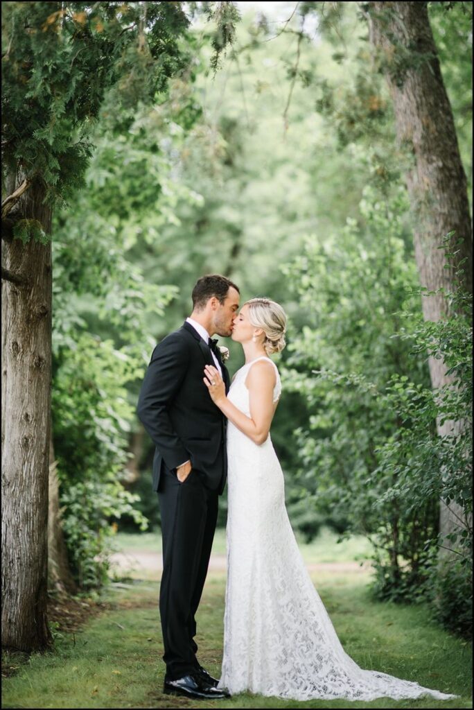 Bride and Groom on the woodsy grounds of The Hutton House