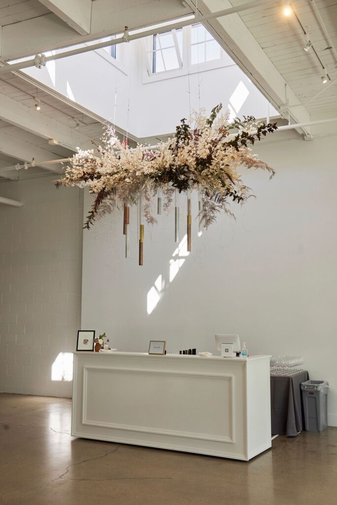 Modern floral chandelier over reception bar