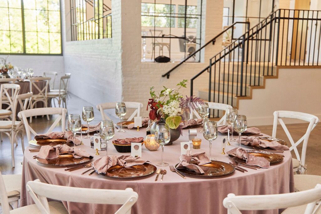 The Whim Minneapolis wedding reception table with rose gold linens and candles