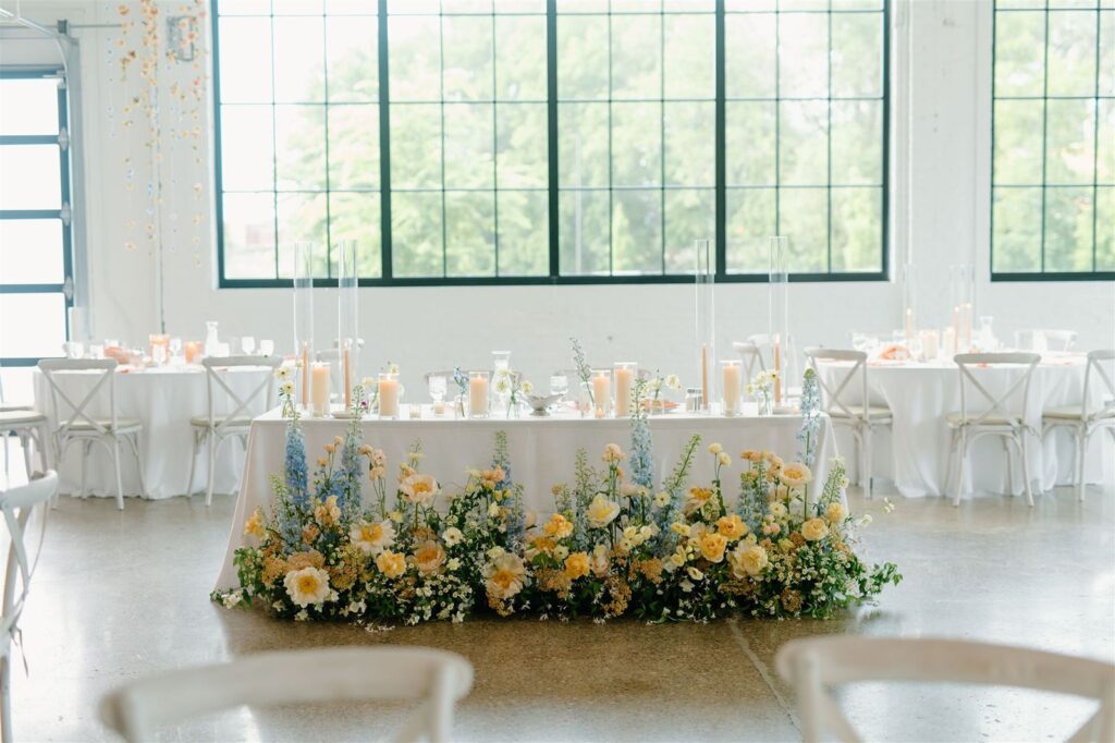 Wedding reception tables in bright white industrial chic venue