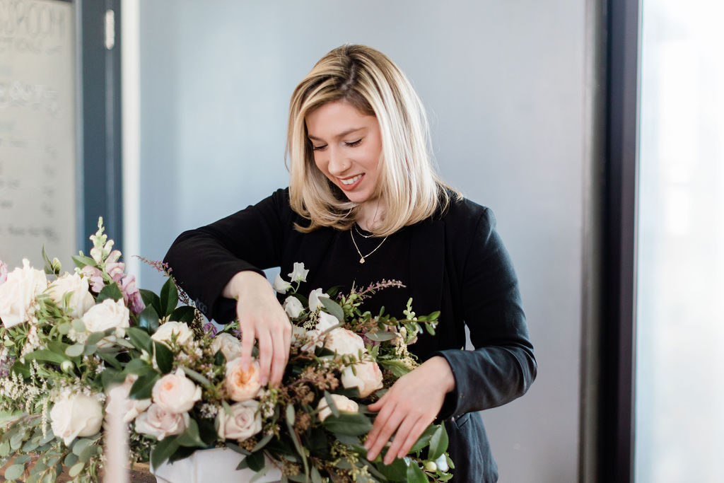 Simply Elegant Group wedding planner arranging floral centerpiece