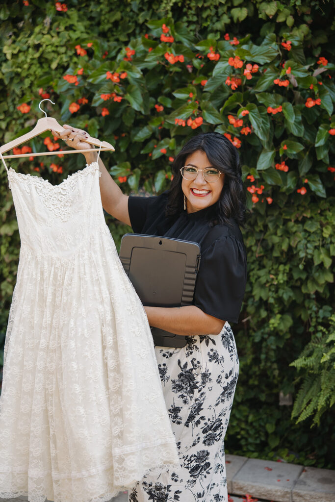wedding planner showing off bridal gown