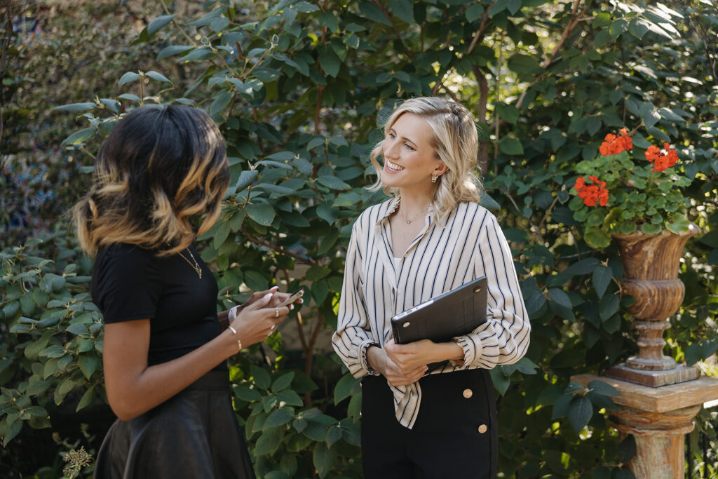 two Simply Elegant Group planners discussing work