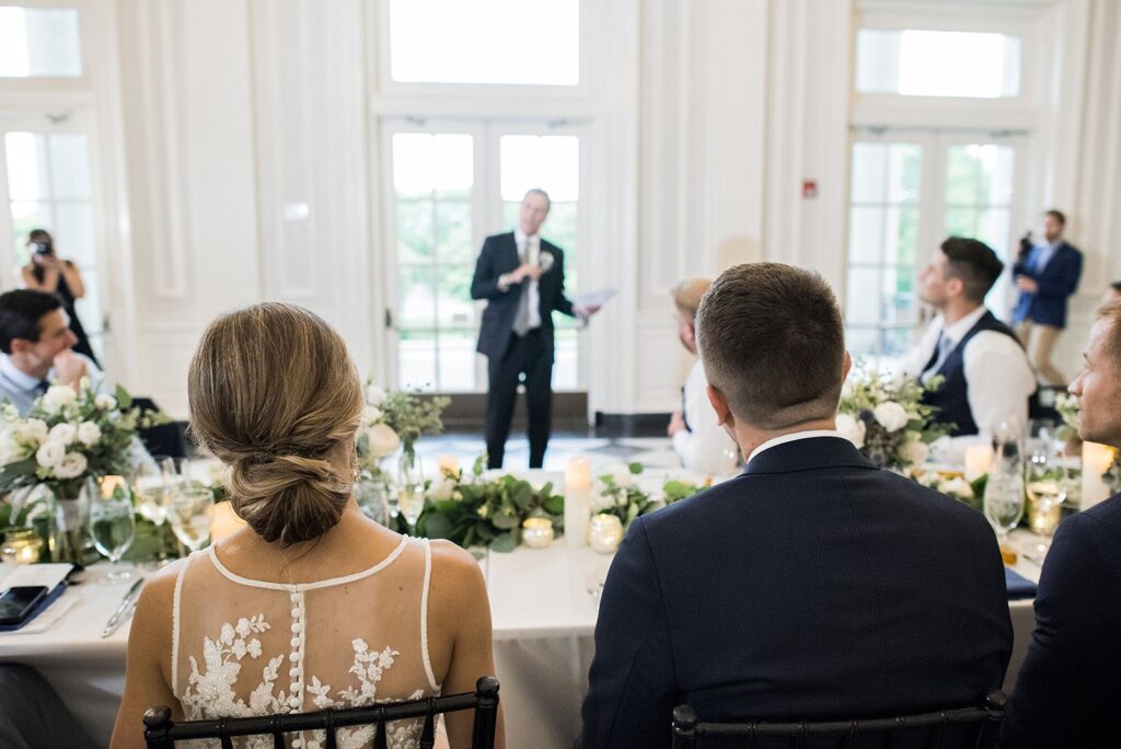 Newlyweds listening to toast at Chicago History Museum wedding.